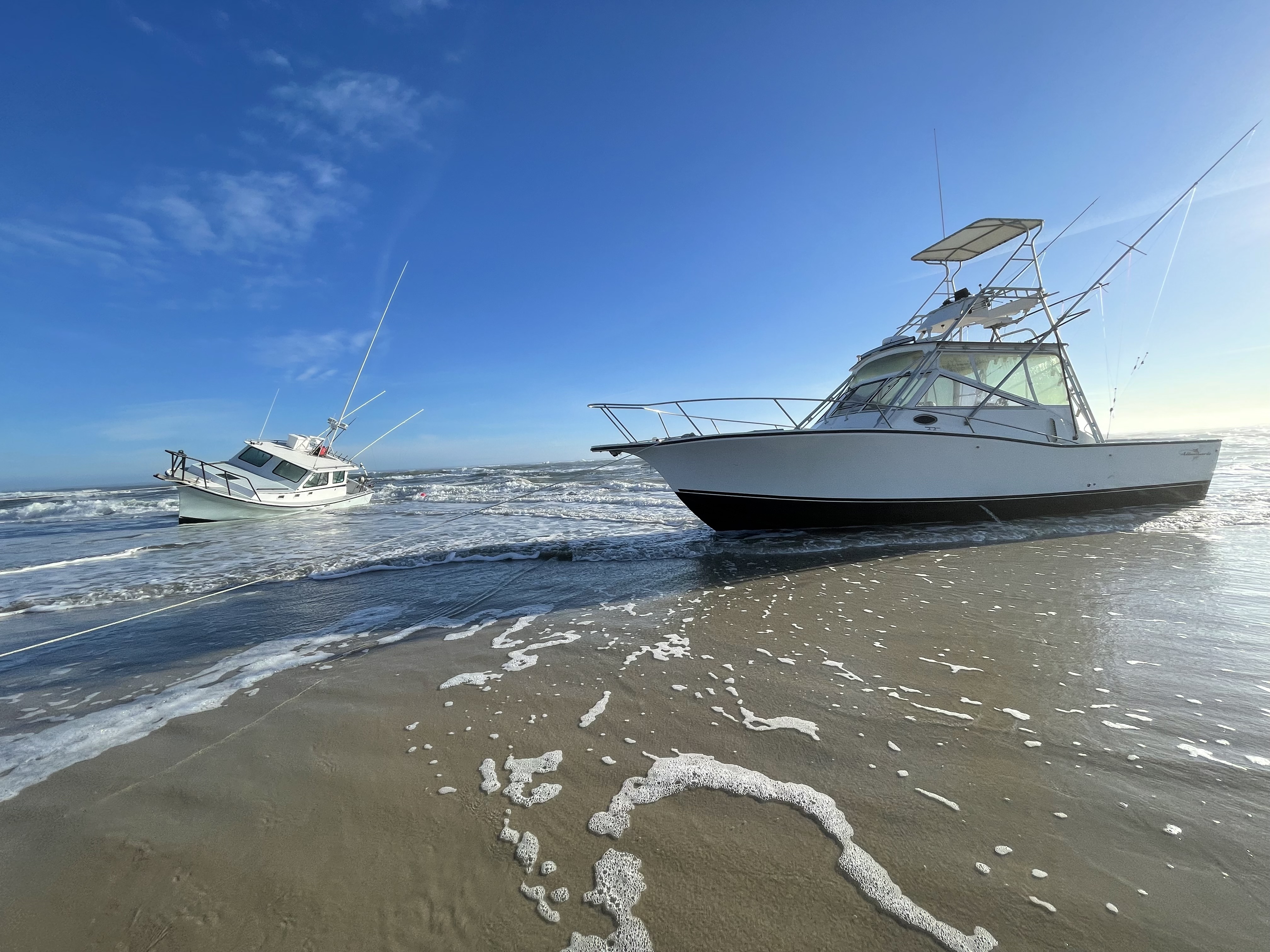Vessels Reel Lucky and Bite Me on Feb. 3, 2022. Two vessels grounded on the beach.