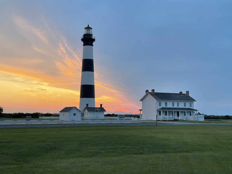 Photo of a beautiful sunrise behind the Bodie Island Light Station.