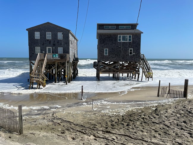 Two oceanfront properties surrounded by ocean water.