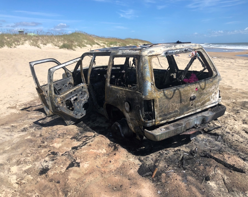 Photo of a vehicle after a fire destroyed it on the beach.