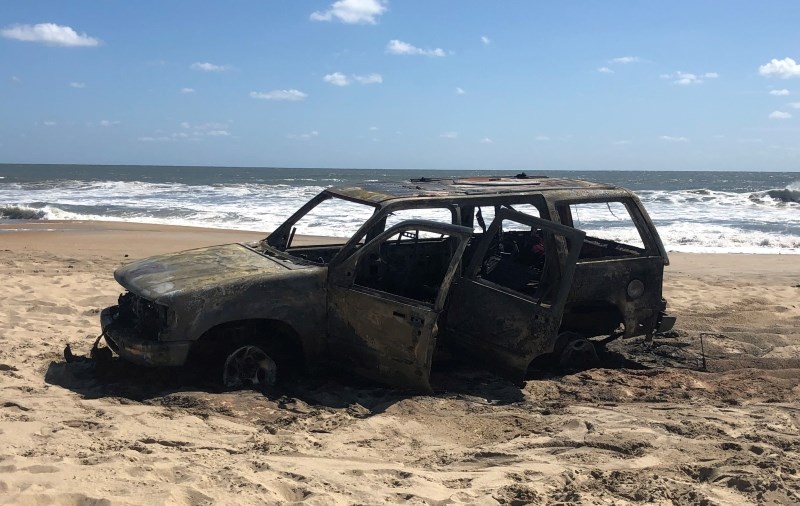 Photo of vehicle destroyed by fire on the beach. Photo of vehicle destroyed by fire on the beach.
