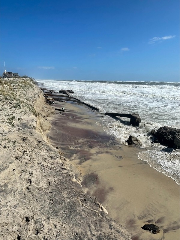 View of beach erosion and exposed infrastructure. Photo showing exposed infrastructure along the beach.