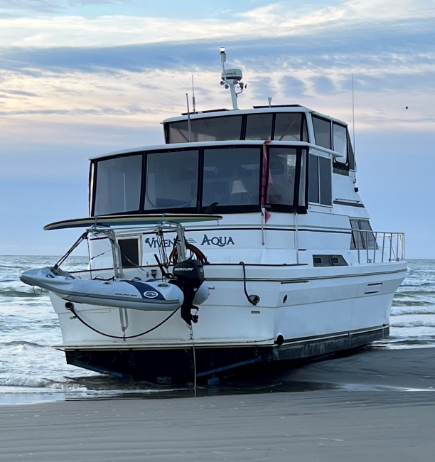 A vessel firmly resting on the beach, waiting to be removed.