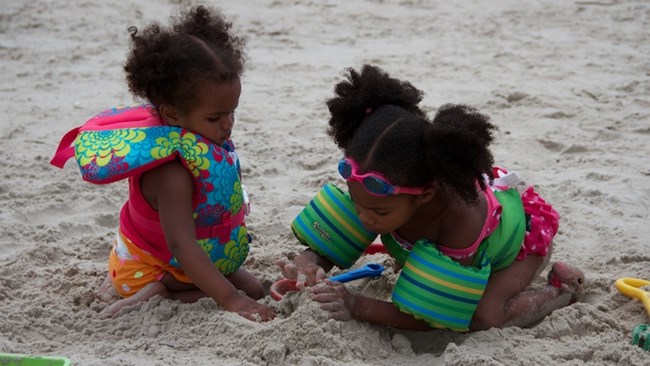 Two kids playing in the sand