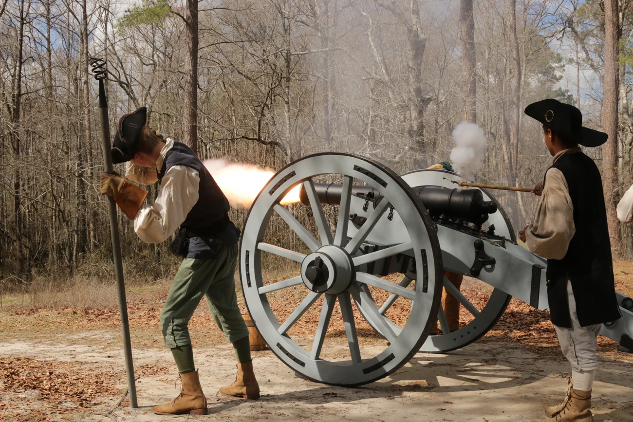 Moores Creek American Revolutionary War reenactors fire a cannon.