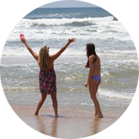 Two visitors enjoy the view as they stroll the beach