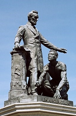 Emancipation Statue of Abraham Lincoln standing over a Freed Enslaved Man with broken chains