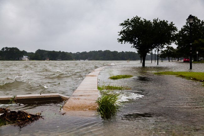 The Lafayette River overflows the shoreline in Norfolk, Virginia during a storm.
