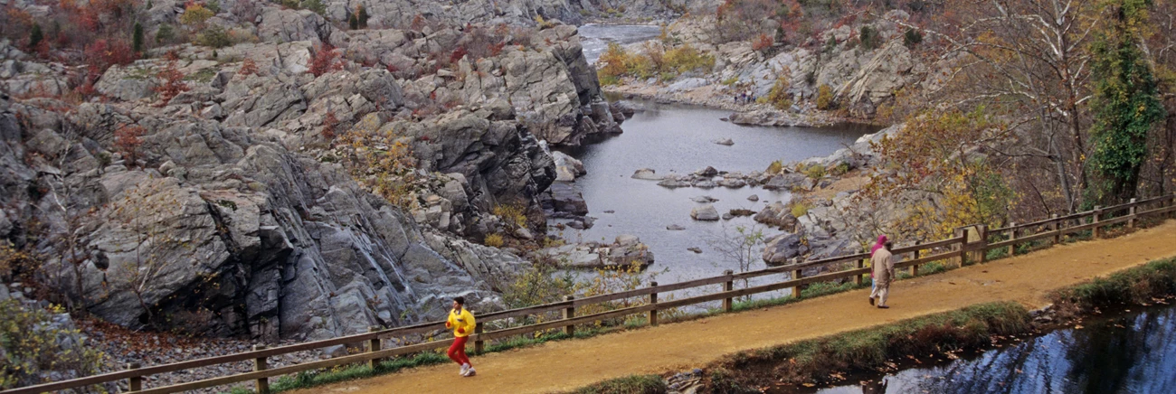 Great Falls of the Potomac A runner and a couple walking along a trail next to Great Falls on the Potomac River