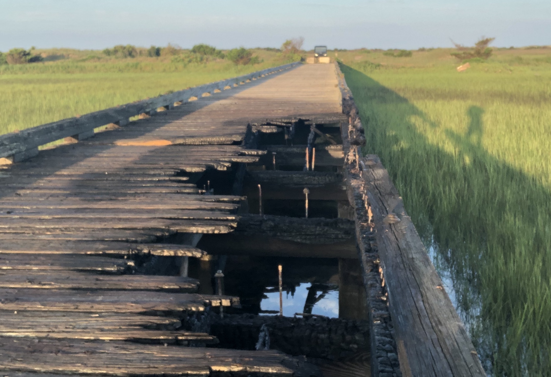 Fire damage to wooden deck and support beams of former US Coast Guard dock in Cape Lookout Bight that occurred July 2, 2020
