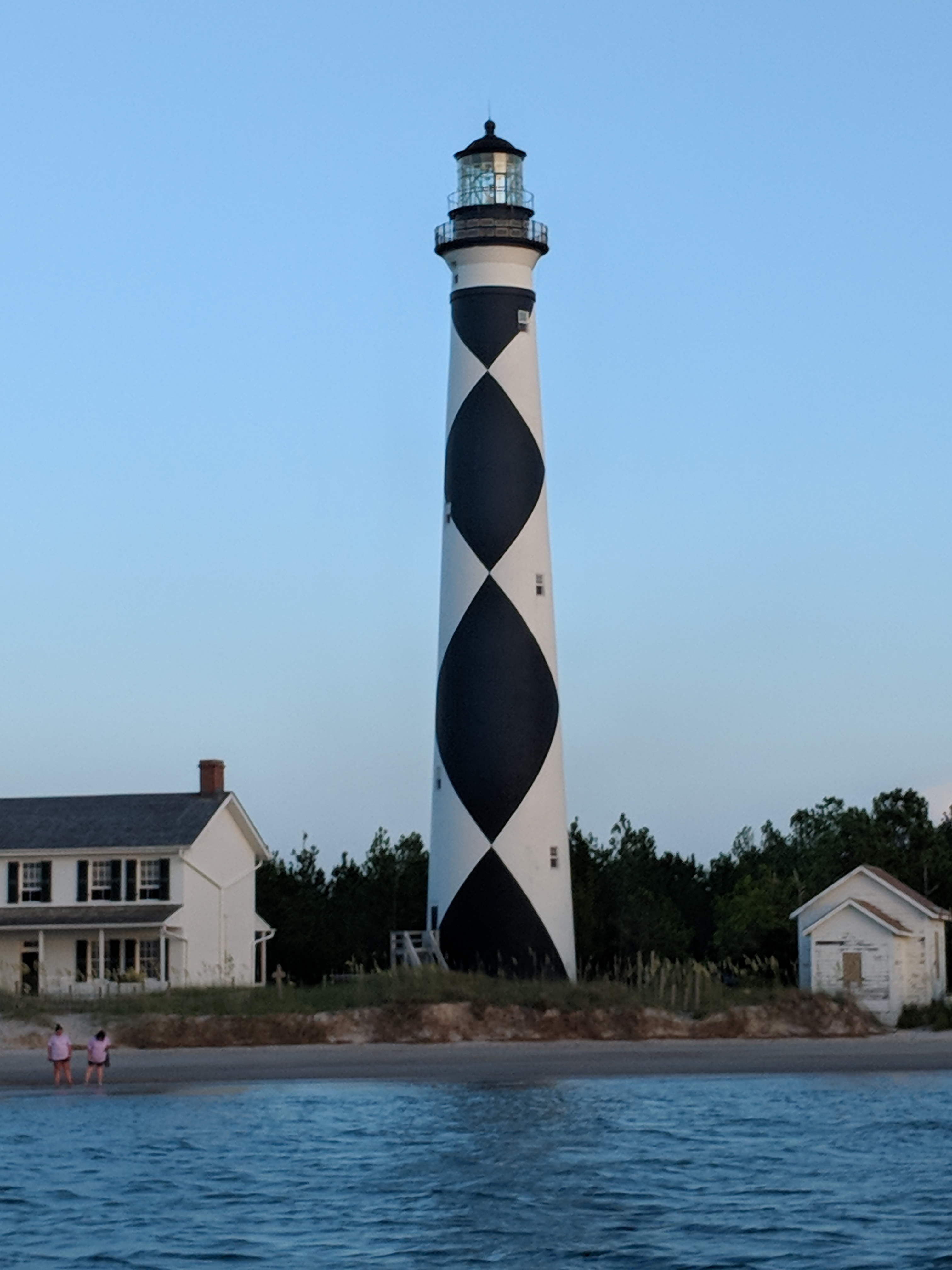 Cape Lookout Lighthouse as seen from the water Cape Lookout Lighthouse, the Keepers' Quarters and a summer kitchen building seen from the water