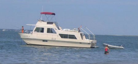 A houseboat anchored off the shores of Cape Lookout National Seashore. A houseboat anchored off the shores of Cape Lookout National Seashore.