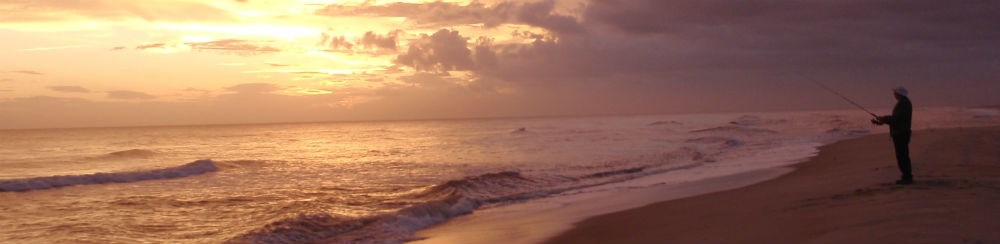 An angler on the beach at sunset. An angler on the beach at sunset.