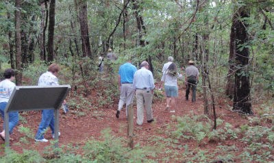 A group of visitors hike a trail.