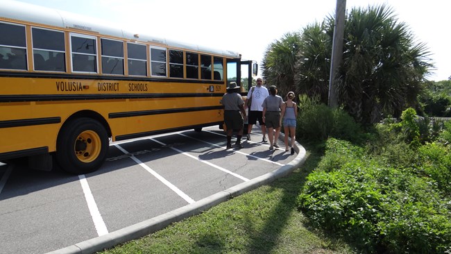 Students exit a school bus.