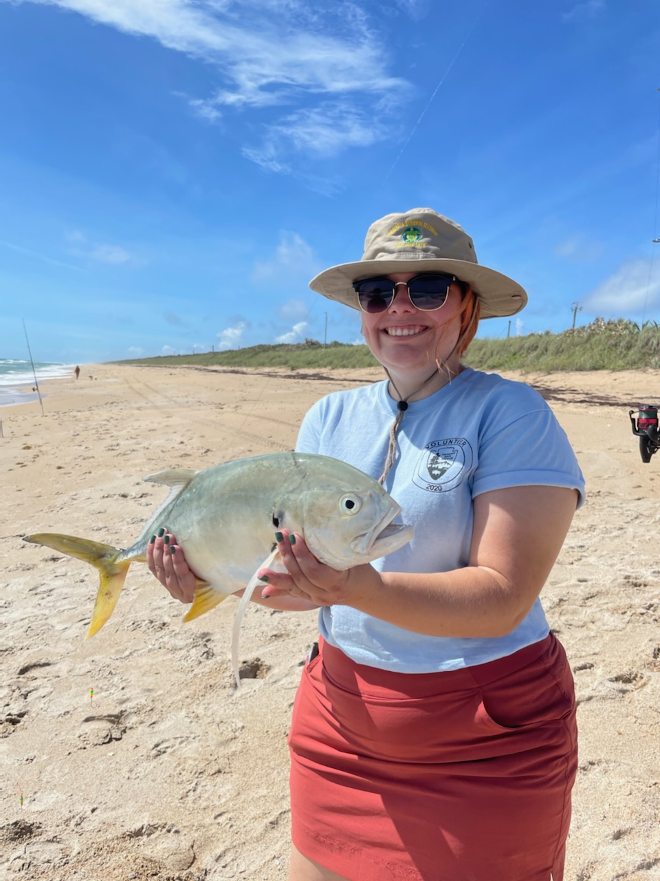 Fisherwoman with fish on the beach.