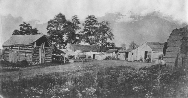 Wooden structures surrounded by trees during the Civil War.