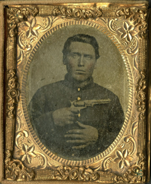 A portrait of a US soldier holding a pistol