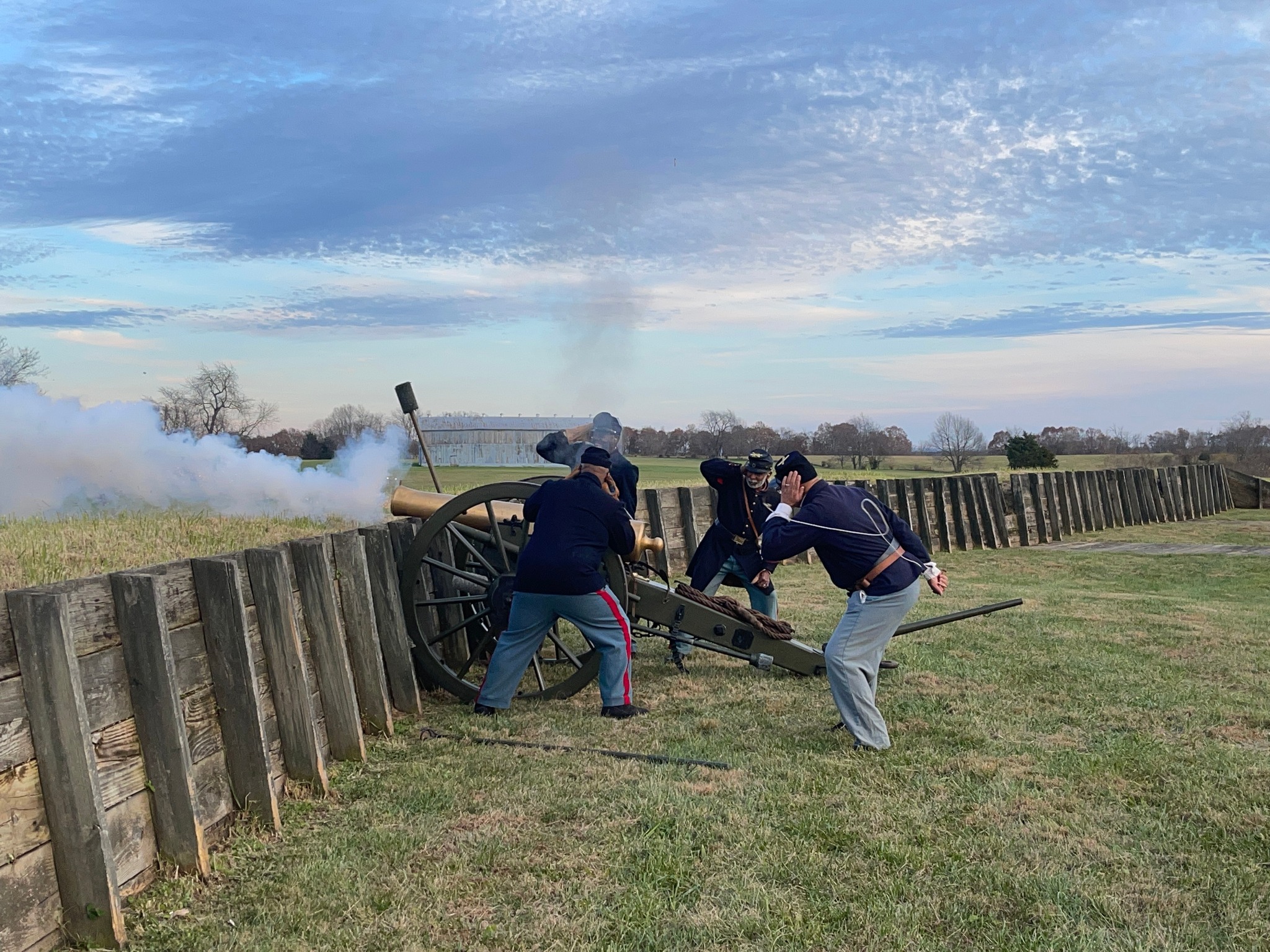 278792362_511669600387353_7252324324530717091_n Four men in Civil War uniforms fire a cannon at a reconstructed fort.
