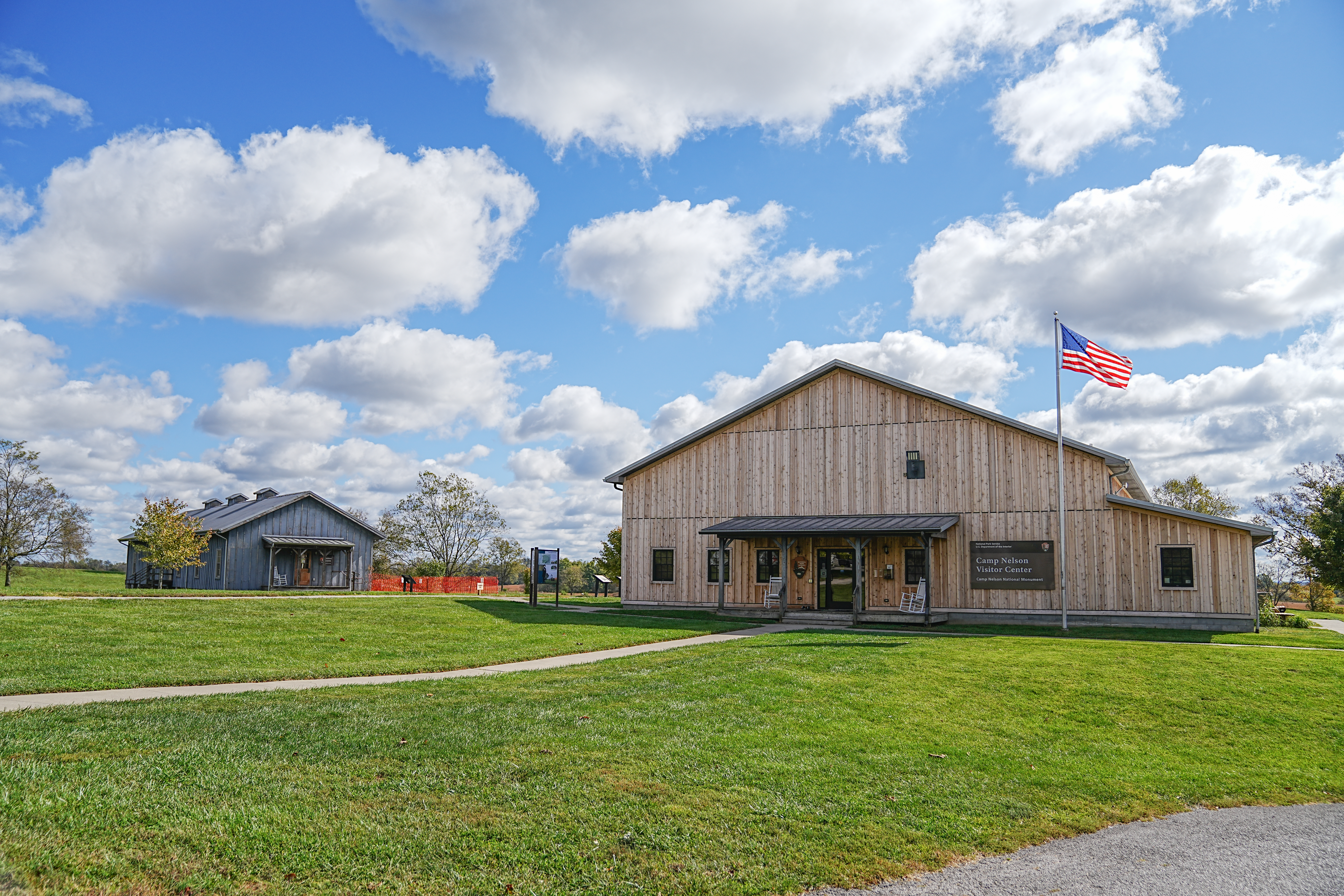 Camp Nelson Visitor Center and Barracks buildings. The Camp Nelson National Monument Visitor Center and Barracks Building side by side on a sunny day.