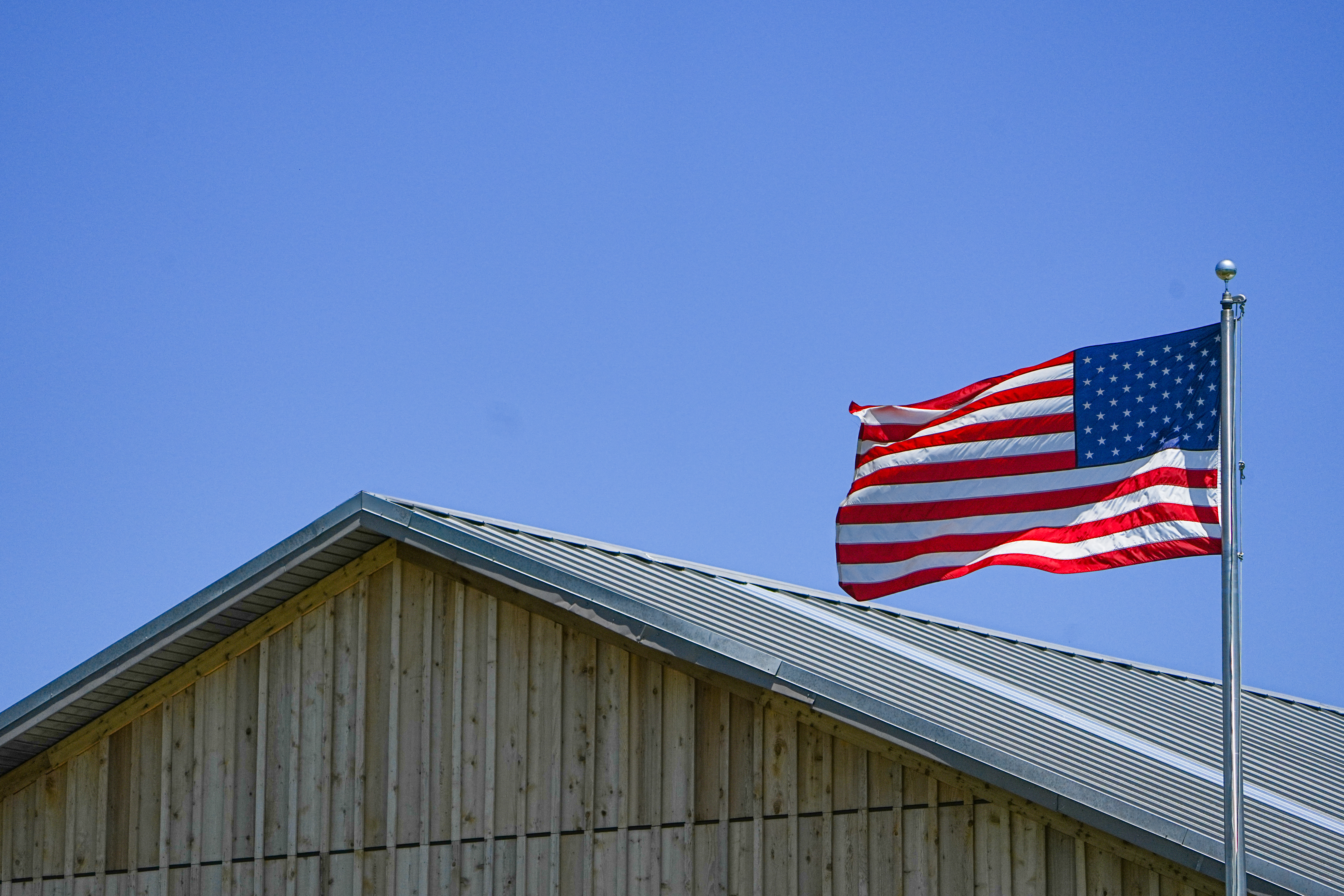 US flag waving over park visitor center.