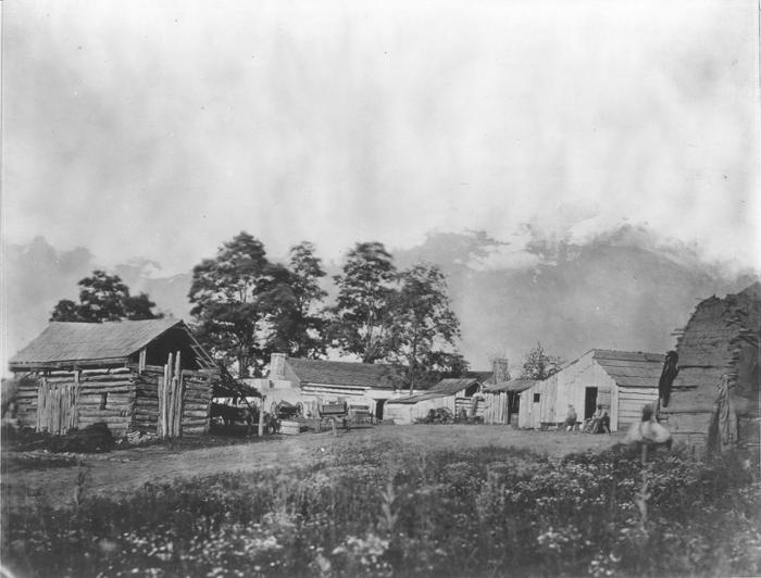 337530952_162148263430121_388724867366392800_n Wooden huts in field with trees in background during Civil War.