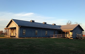 Dusk light settles on large wooden barracks building.