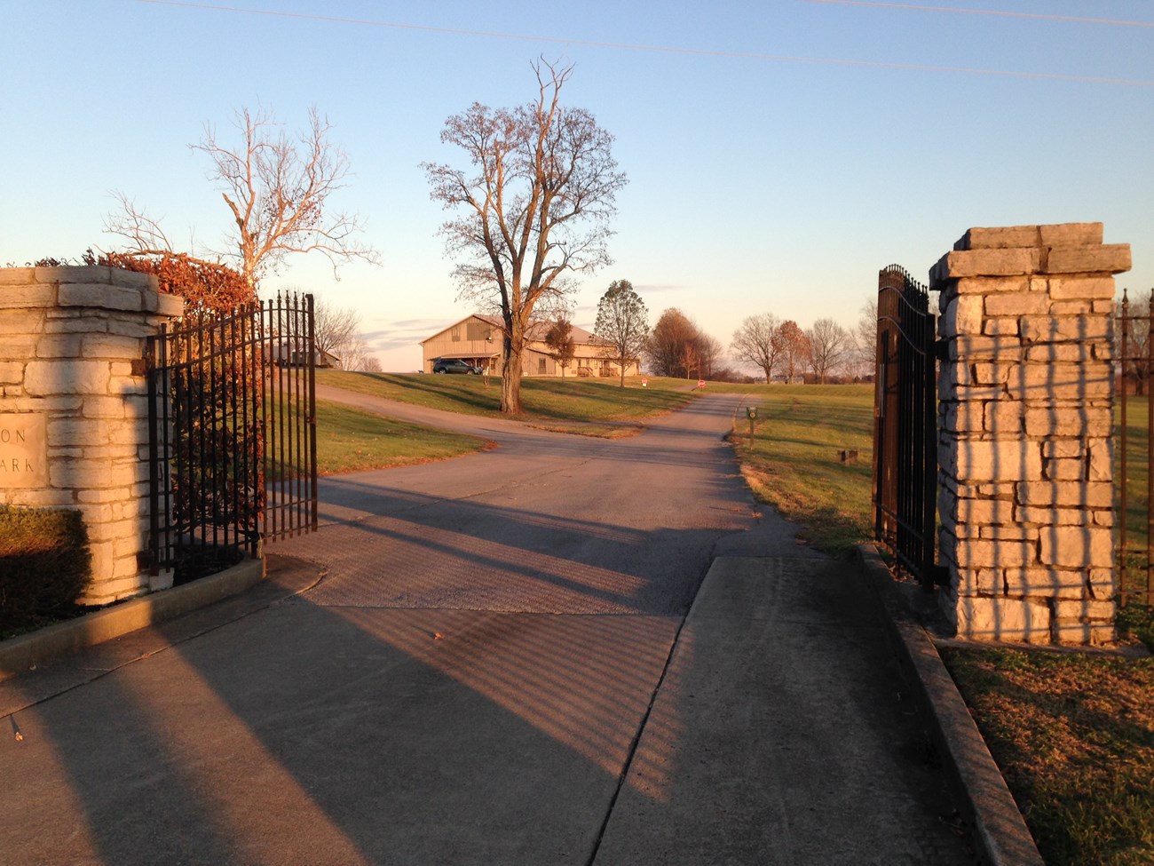 Open gates of Camp Nelson National Monument and driveway into park.