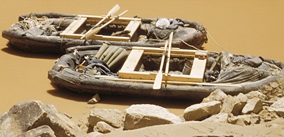 two rafts moored on a river bank