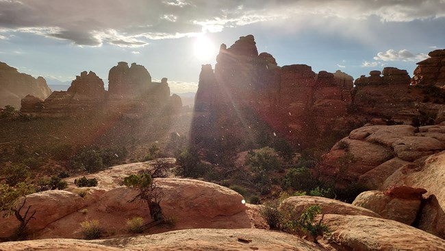 Sun beam and rain over desert stone spires