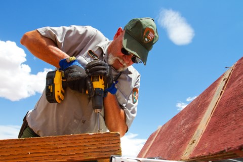 a worker uses a cordless drill