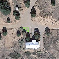 an aerial image of a building with an area marked in green