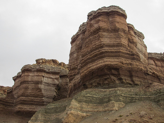 Brown, layered cliffs of the Sommerville Formation along the road to Hans Flat.