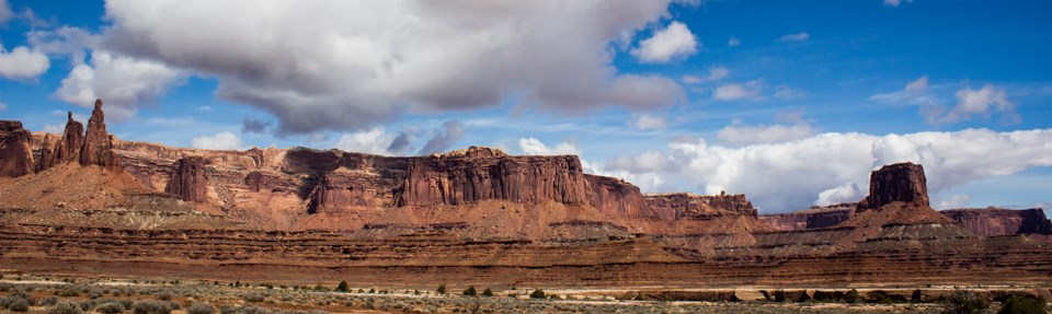 tall rock pinnacles and buttes with patchy clouds overhead