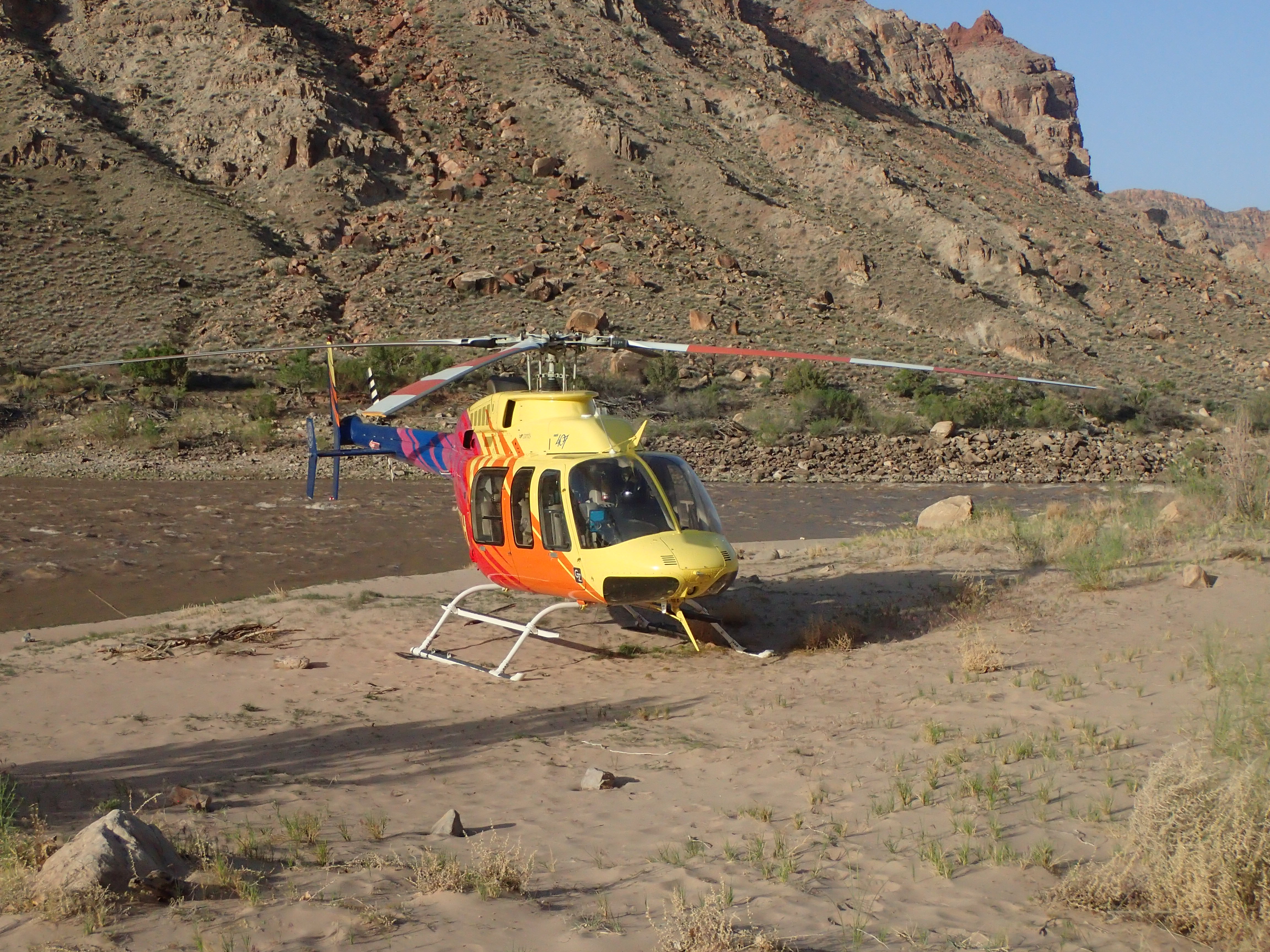 Helicopter landing on a riverbank