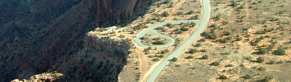 An aerial view of a road near a viewpoint An aerial view of a road near a viewpoint
