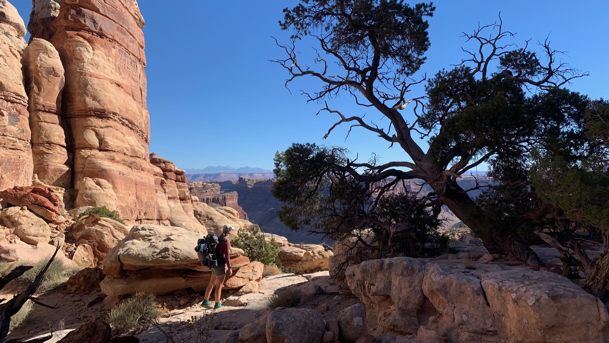 Hiker stands by a rock formation