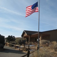 An American flag flies in front of a building