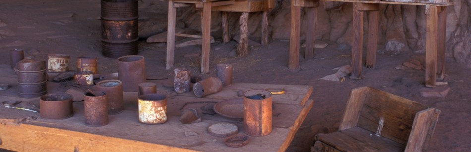 a wooden table with rusted cans a wooden table with rusted cans
