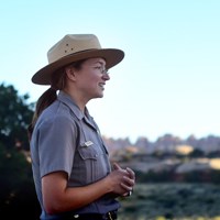 A park ranger smiles