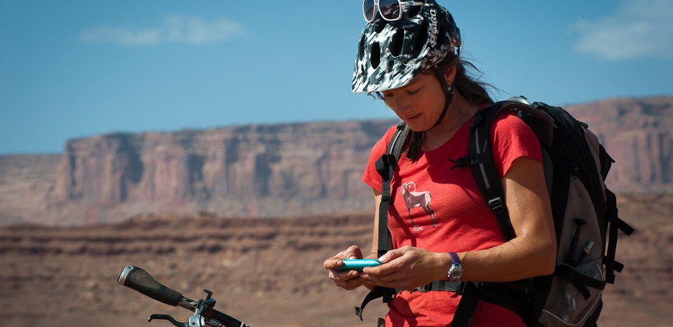 A woman looks at a cell phone