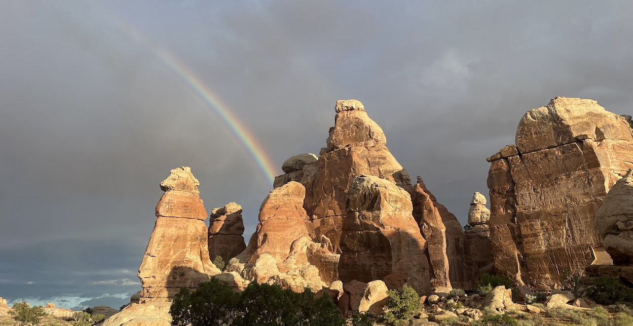a rainbow over rock formations