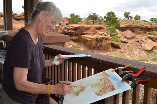 Artist painting scenery at the 2016 Arts and the Park: Light on the Reef event