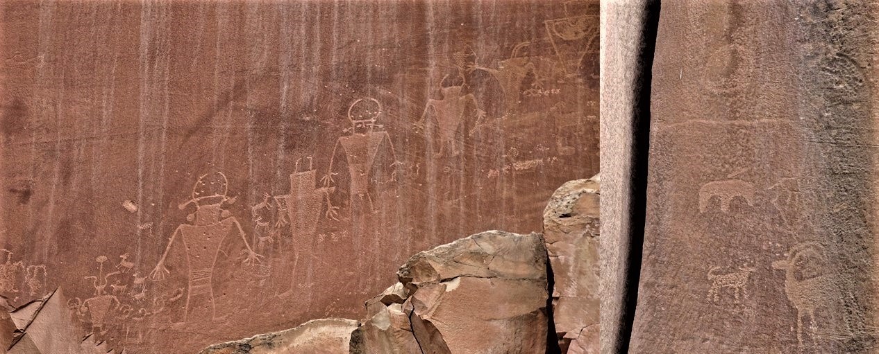 Bighorn sheep and human-like images carved and pecked into sandstone