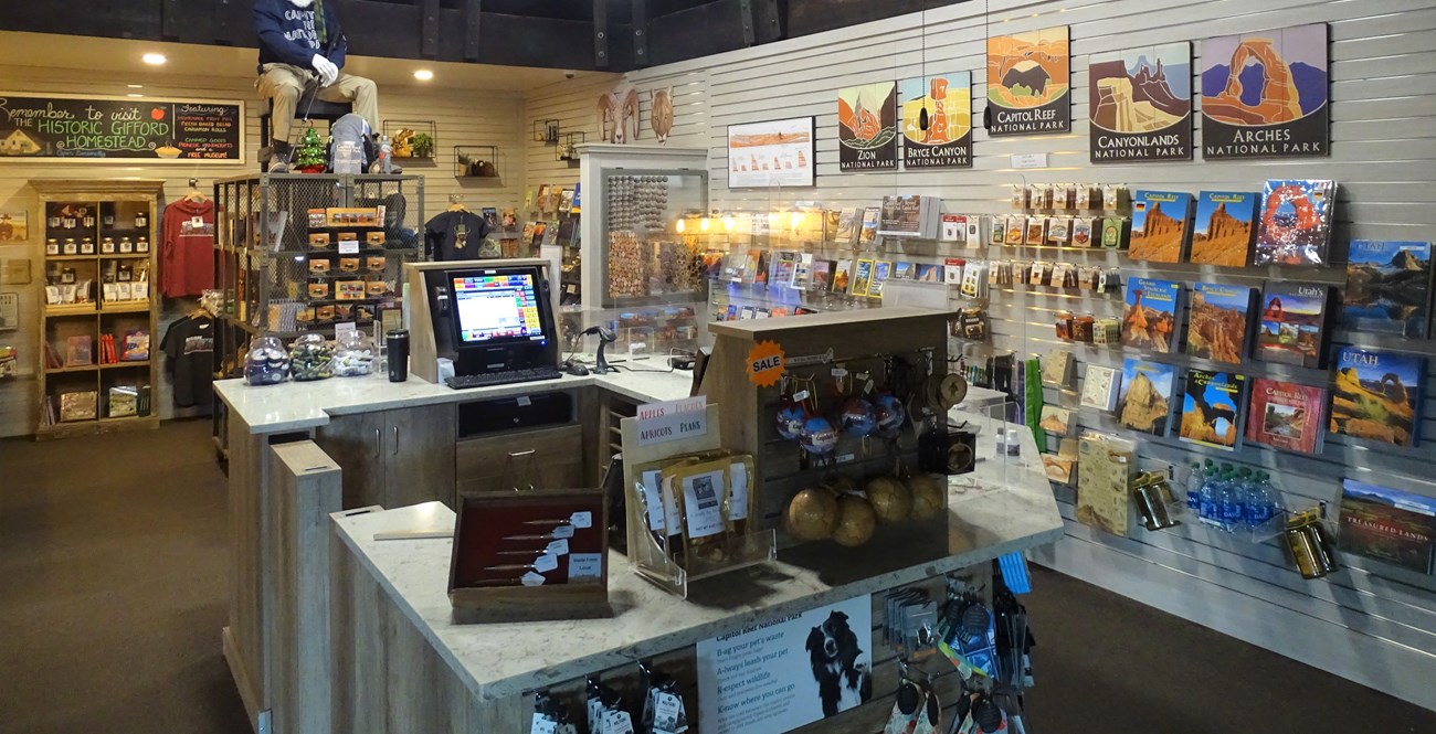 Interior of a store with walls and shelves stocked with items.