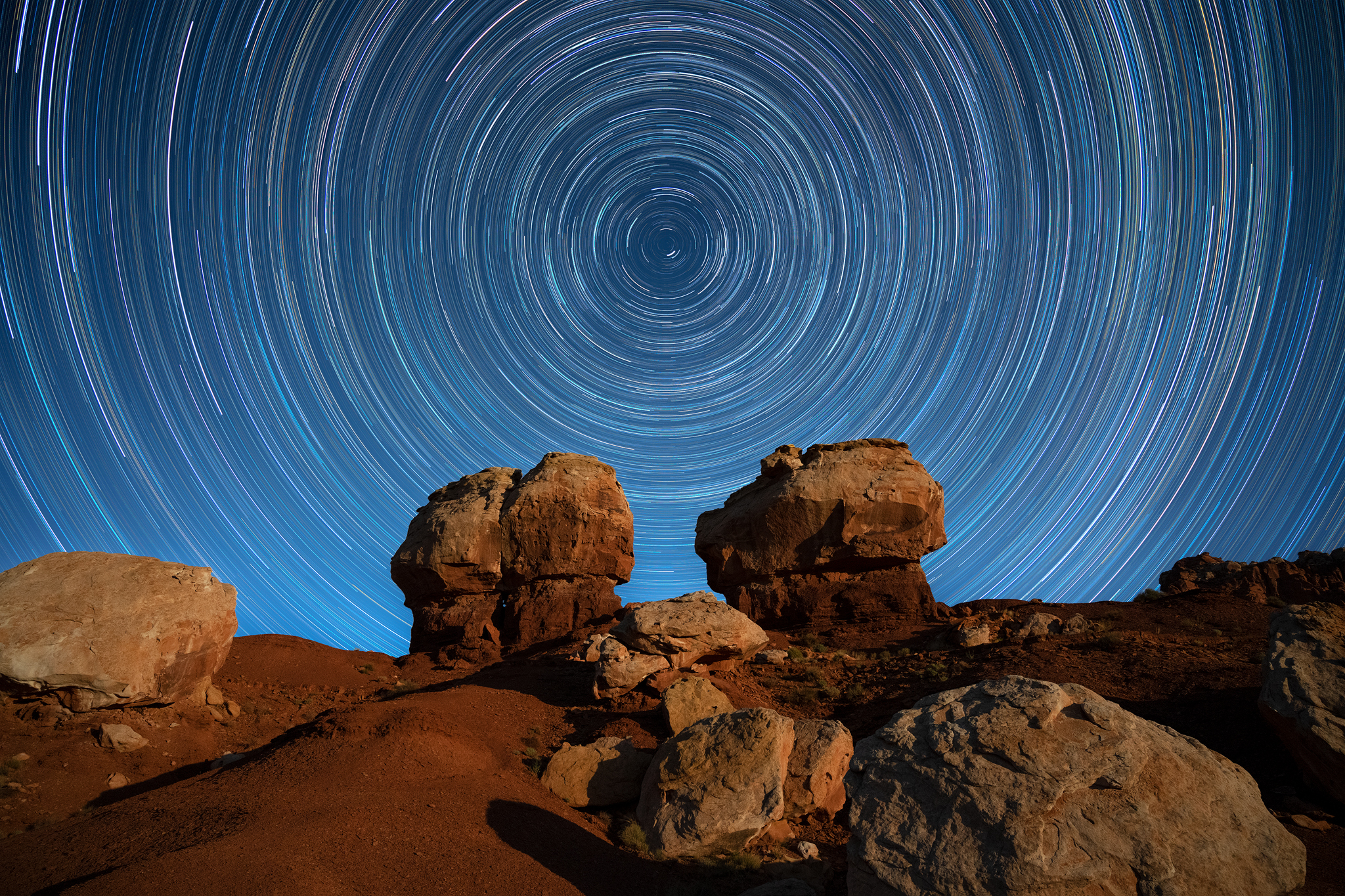 Maelstrom circumpolar star trails above twin rock formations