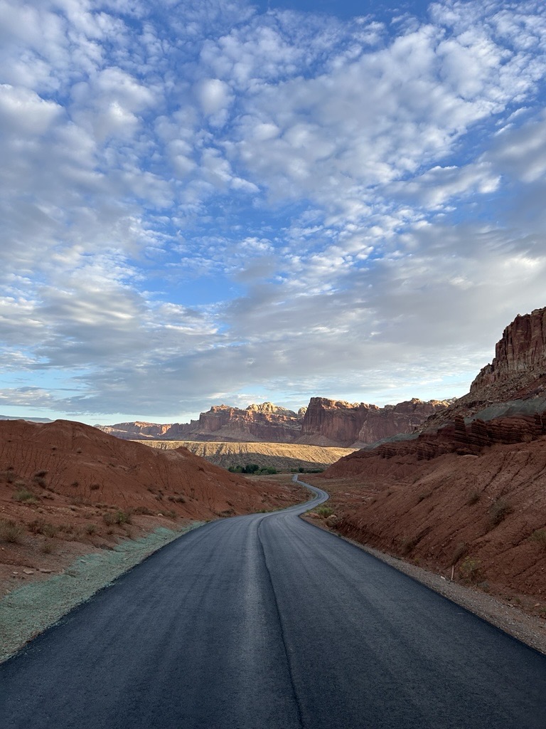 Scenic Drive from Danish Hill A ribbon of black asphalt amid red hills and sandstone cliffs.