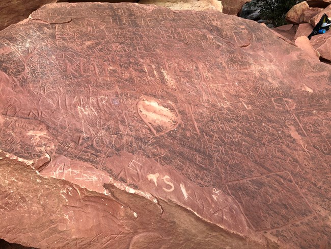 layers of carvings in a red rock