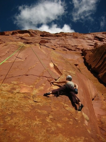 A rock climber on red sandstone