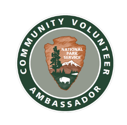 Learn about the Community Volunteer Ambassador program. Community Volunteer Ambassador logo featuring the NPS arrowhead in a light green circle ringed by a dark green circle.